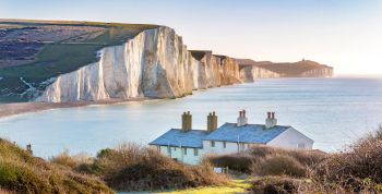 The Coast Guard Cottages and Seven Sisters Chalk Cliffs just outside Eastbourne, Sussex, England, UK.
