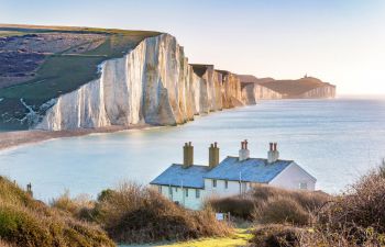The Coast Guard Cottages and Seven Sisters Chalk Cliffs just outside Eastbourne, Sussex, England, UK.