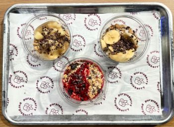 Three bowls with variations of fruit, granola and breakfast toppings