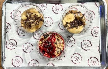 Three bowls with variations of fruit, granola and breakfast toppings