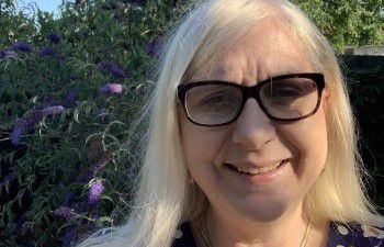 Professor Antonella De Santo standing in a garden smiling at the camera