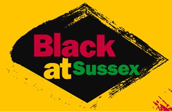 Black at Sussex text with black lozenge shape on yellow background