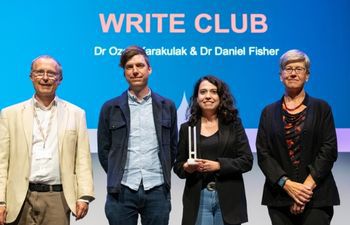 Daniel Fisher and Ozgu Karakulak- Winners of Research and Innovation Culture. Accepting award on stage at Sussex Awards.