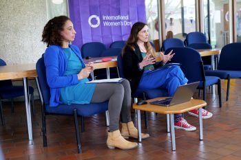 Image of two women sitting in front of a room