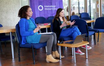 Image of two women sitting in front of a room