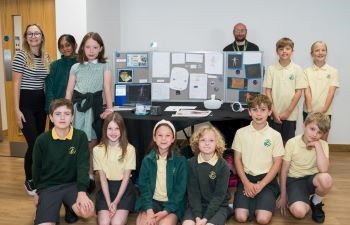 Dr Daniel Creed and several students smiling at the camera