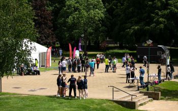 Groups of students in Library Square in the sun