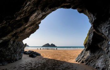 View from inside a cave looking out onto a beach