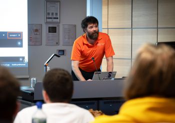 Person presenting to a group of people.