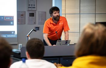 Person presenting to a group of people.