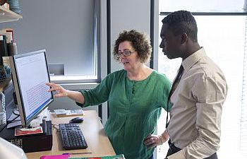 Two people looking at a computer screen
