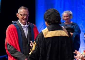 Simon Watney greeting Chancellor Sanjeev Bhaskar