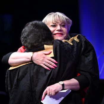 Suzy (Eddie) Izzard greeting Chancellor Sanjeev Bhaskar
