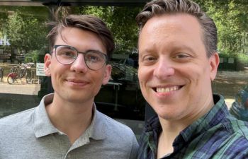 Mentee Mateusz Kobylec and mentor Aymeric Monod-Gayraud taking a selfie together outside in Hammersmith.