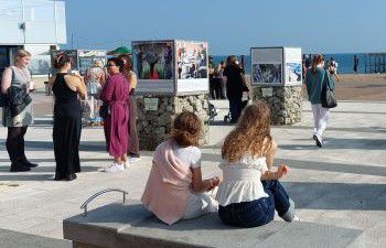 Outdoor photo exhibition on Brighton Beach on a sunny day
