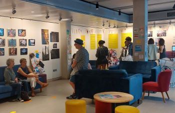 People exploring artwork in a modern indoor gallery