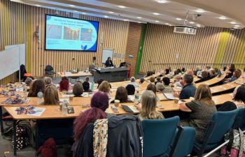 A photograph showing a busy lecture theatre being addressed by a speaker at the conference 'Discussing Death and Loss in the Classroom'