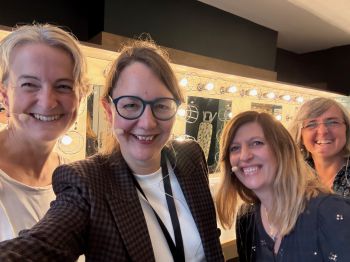 The 4 panellists are shown close up and smiling in a