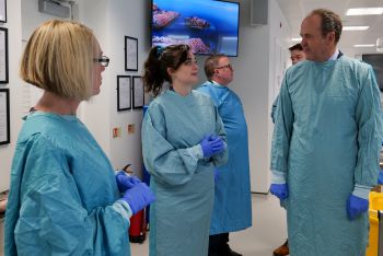 The Lord Lieutenant of East Sussex meeting staff and students in blue scrubs in the anatomy suite at BSMS