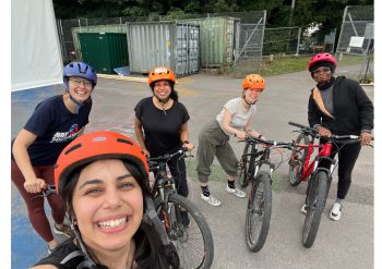 Participants posing and smiling after the successful cycling course