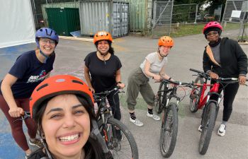 Participants posing and smiling after the successful cycling course