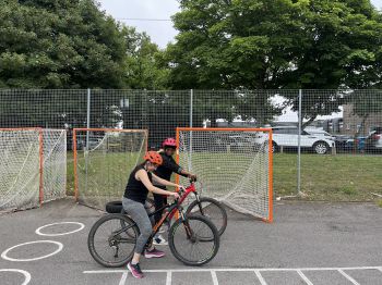 One cyclist encouraging the other while learning
