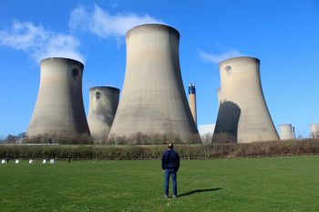 Photo of a man standing outside a power station