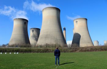 Photo of a man standing outside a power station