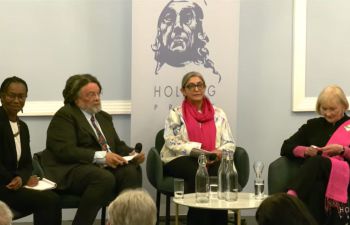 Gurminder and fellow panellists are seated in a semi-circle for the Q&A session following their individual presentations
