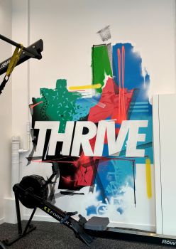 A photo of a wall graphic that says 'Thrive' in Active Arches workout space on the University of Sussex campus