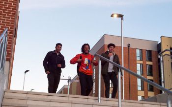 Students walking down the steps of the student village
