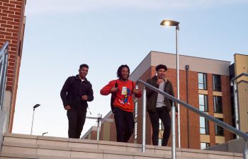Students walking down the steps of the student village