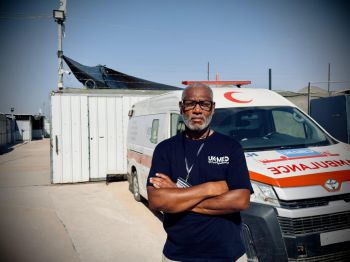 Prof Martin Griffiths pictured in Gaza in front of an ambulance
