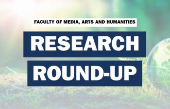A sunlit forest with a green globe with the words Research Round-up written on the top