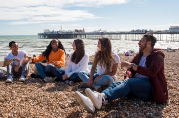 Summer School students laughing on Brighton beach