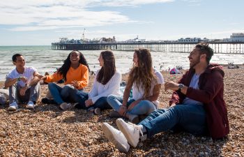 Summer School students laughing on Brighton beach