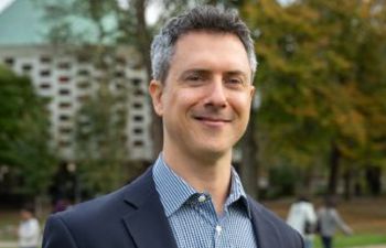 Academic Guy Edwards smiles at the camera