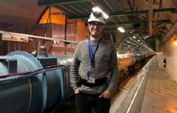 A scientist wearing a helmut inside a tunnel at the Large Hadron Collider, CERN, Switzerland