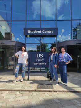 Ukrainian Summer School Students, Yuliia, Polina and Juliia  standing in front of the Student Centre on campus