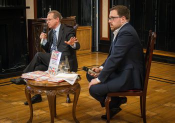 Aleks Szczerbiak (left) and Jakub Krupa (right) are shown mid-conversation at the launch of Alek's new book at the Polish Embassy in London.