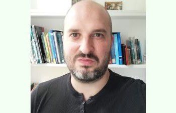 Dan Sumner in an office looking at the camera