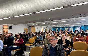 Showing people attending launch sitting down listening to a talk