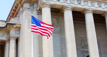 A picture of the US Supreme Court with an American flag waving in front of it