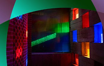 Light shining through Meeting House stained glass windows