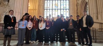 Business and Management students from the University of Sussex stand together at the Houses of Parliament after presenting sustainability projects.