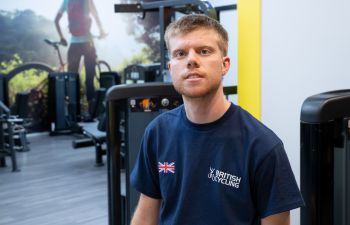 Freddy Ireland seated in the campus gym and smiling at the camera