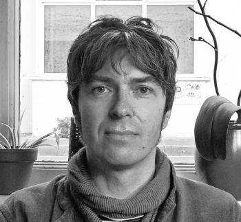 black and white photograph of Jason Douglas face with a window behind him