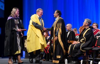 Eric Smith and his daughter Catrine Priestley are greeted by Chancellor Sanjeev Bhaskar and Vice-Chancellor Sasha Roseneil
