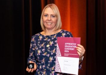 Nichola Sedge holding her Apprentice Graduation certificate