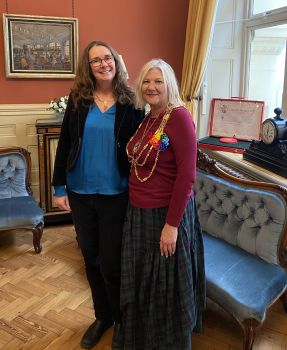 A photo of Vicky Bromley standing to the left of B&H Council's Mayor, Councillor Amanda Grimshaw, at the Mayoral Parlour where Vicky was invited for tea.